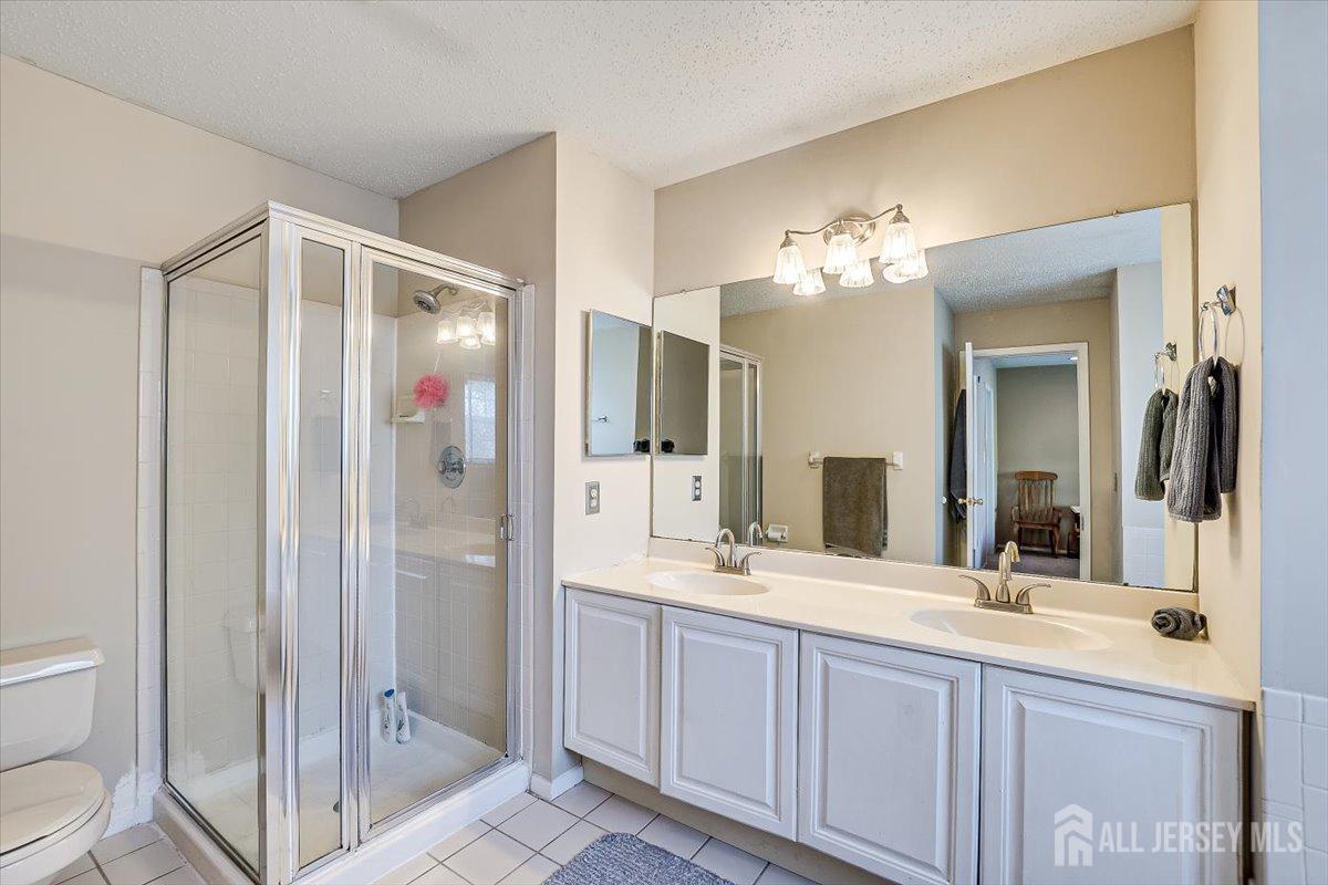 230 Nebula Road Piscataway, NJ 08854 - Photo 22 of 33 a bathroom with a double vanity sink mirror and toilet
