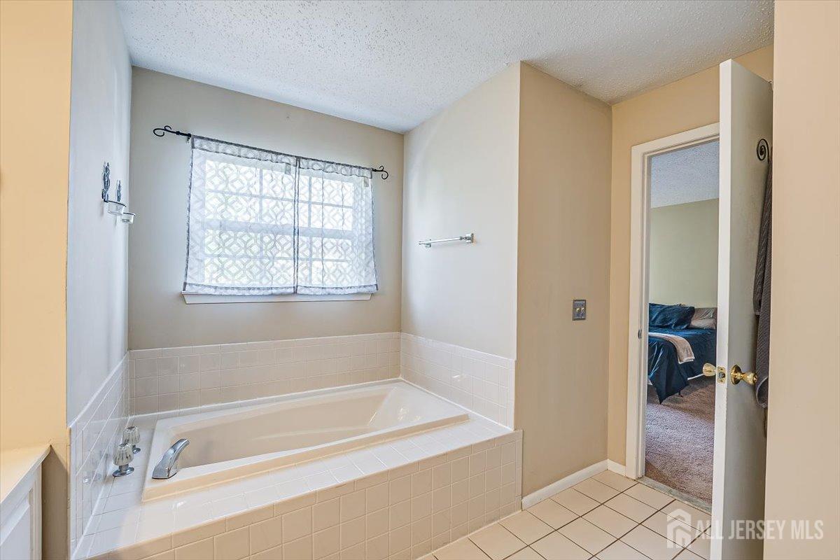 230 Nebula Road Piscataway, NJ 08854 - Photo 23 of 33 a bathroom with a tub shower and sink