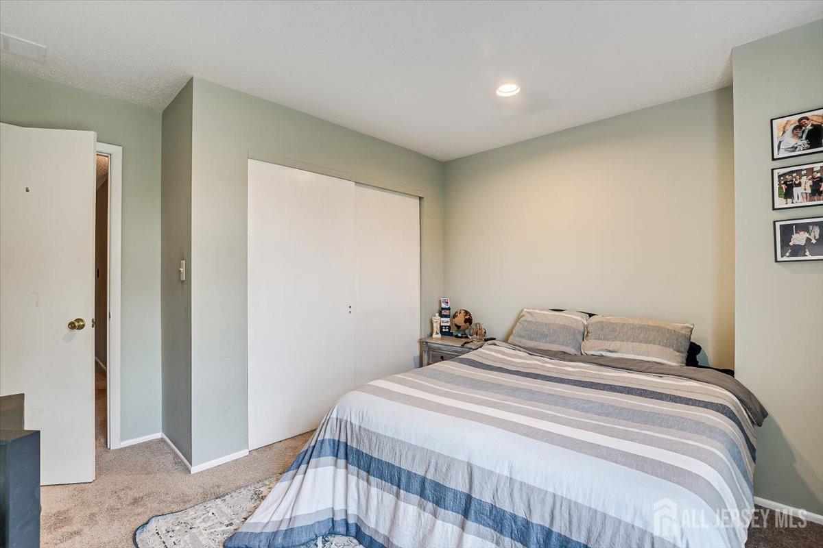 230 Nebula Road Piscataway, NJ 08854 - Photo 25 of 33 a bedroom with a bed and a painting on the wall