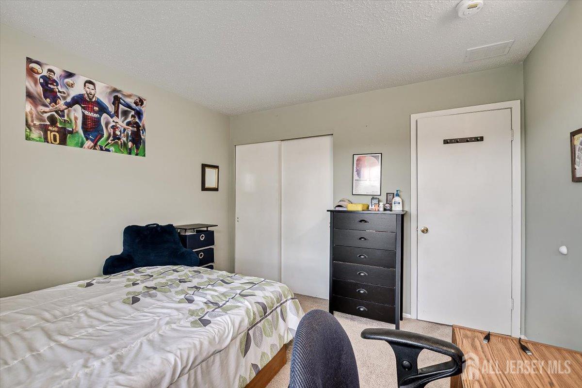 230 Nebula Road Piscataway, NJ 08854 - Photo 27 of 33 a bedroom with a bed and a dresser