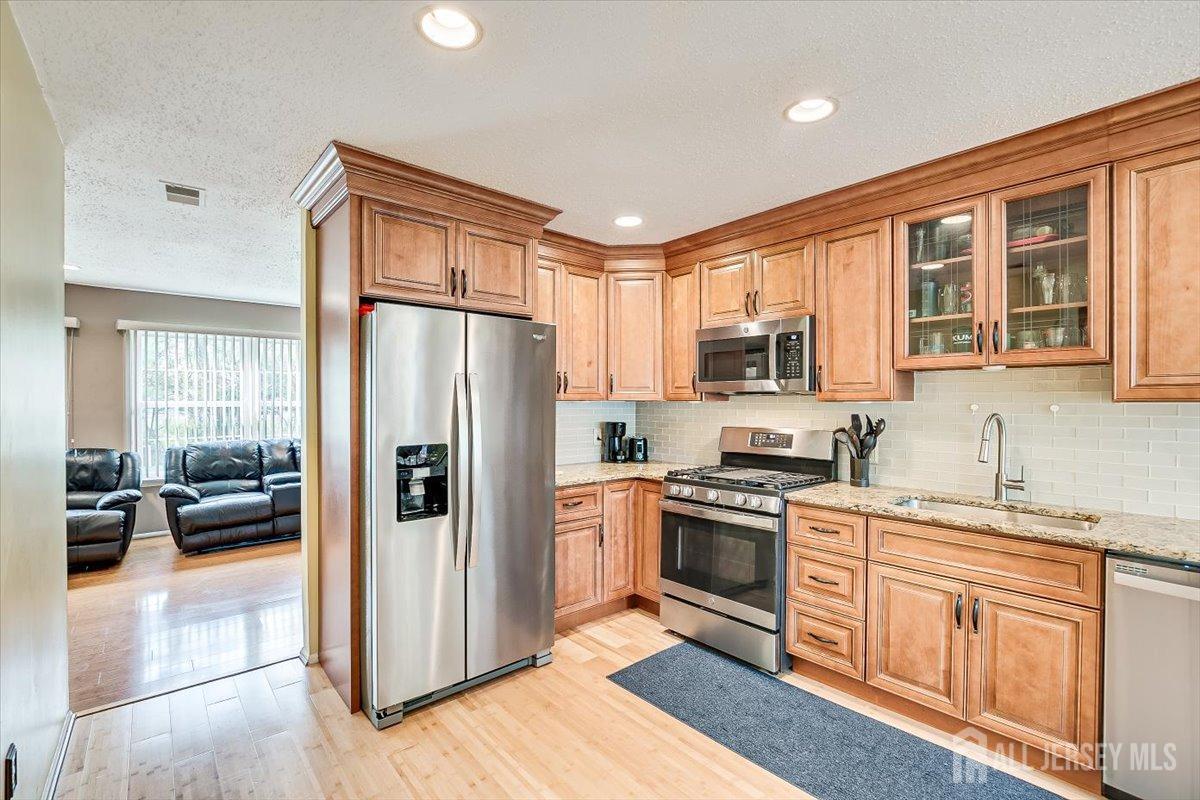 230 Nebula Road Piscataway, NJ 08854 - Photo 7 of 33 a kitchen with stainless steel appliances granite countertop a refrigerator stove and sink