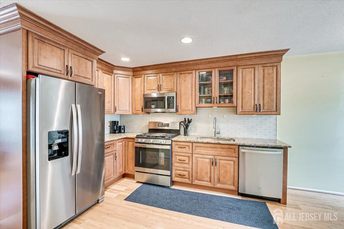 230 Nebula Road Piscataway, NJ 08854 - Photo 8 of 33 a kitchen with stainless steel appliances granite countertop a refrigerator sink and stove