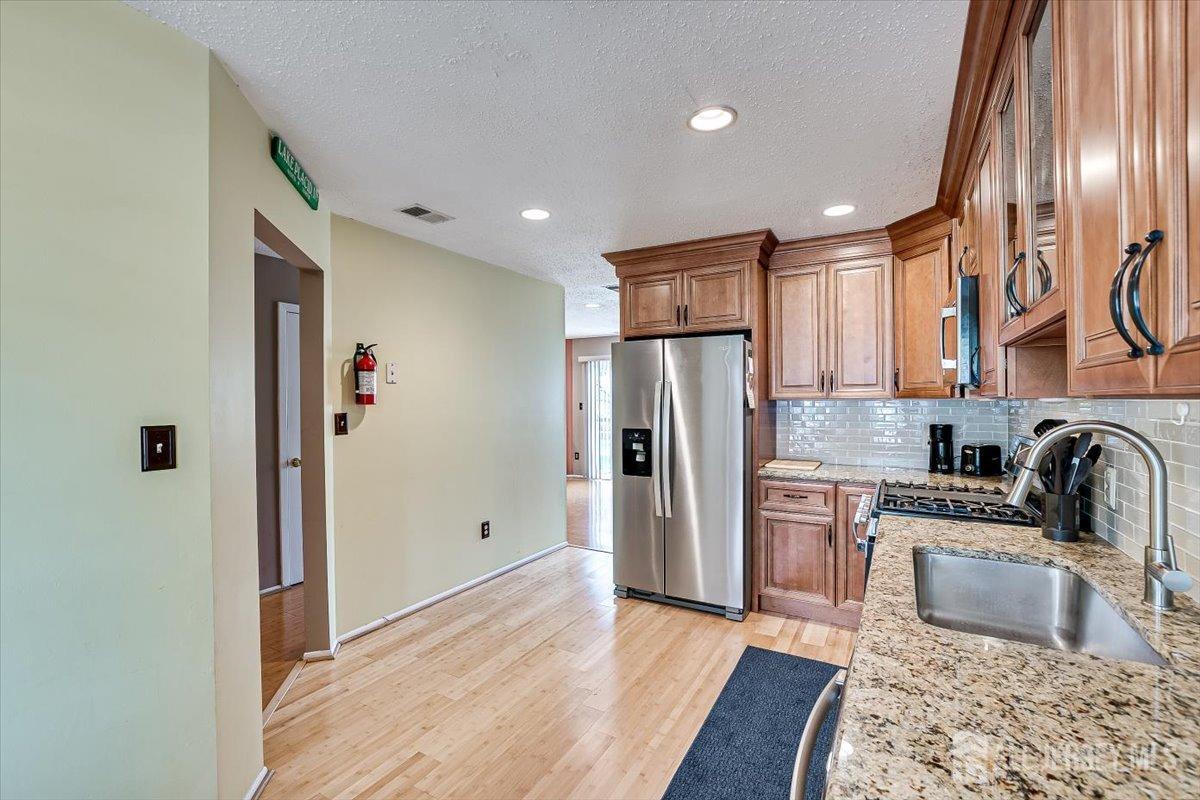 230 Nebula Road Piscataway, NJ 08854 - Photo 10 of 33 a kitchen with stainless steel appliances granite countertop a refrigerator and a sink