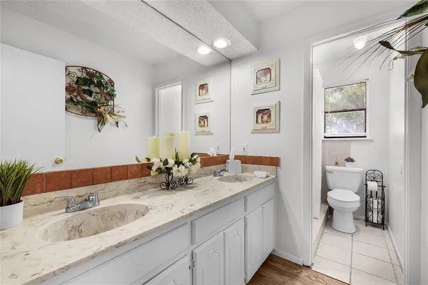 a bathroom with a toilet sink and mirror