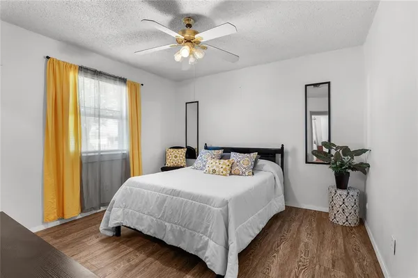 a bedroom with a bed and a chandelier