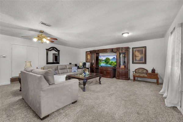 a living room with furniture and a lamp