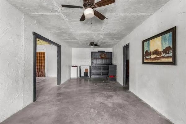 a view of a livingroom with furniture and a ceiling fan