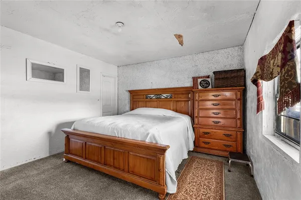 a bedroom with a bed and a cabinets