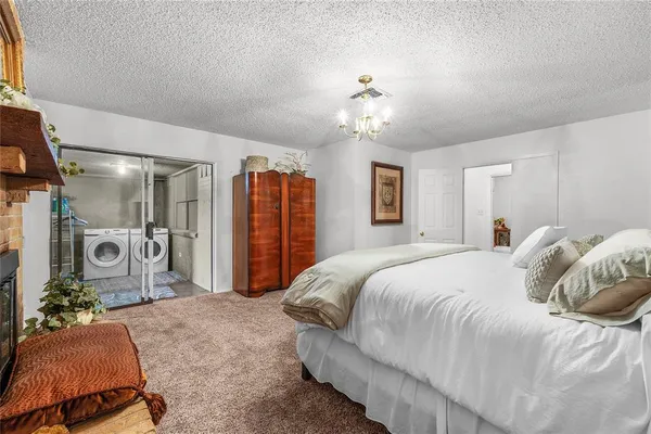 a spacious bedroom with a bed and ceiling fan