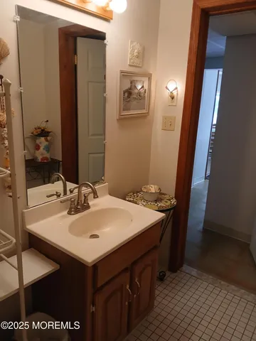 a bathroom with a toilet and a painting on the wall