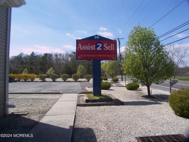 a view of a street with benches in the background