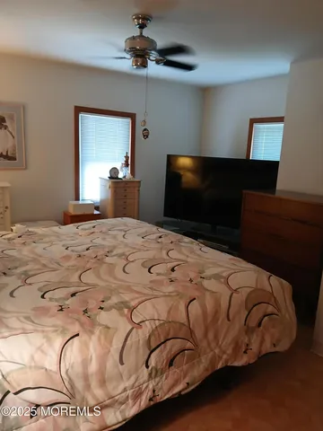 a view of a hallway and a livingroom with furniture