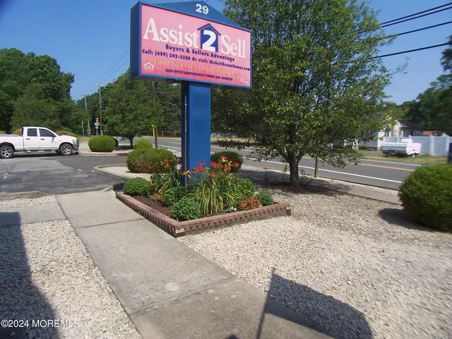 a street sign on a sidewalk next to a road