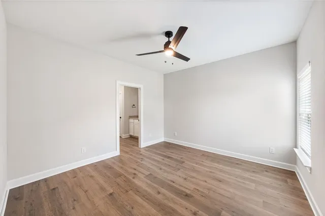 a view of a kitchen with a sink and wooden floor