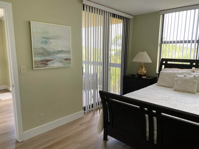 a view of a room that has a bed and a window