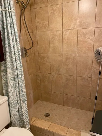 a bathroom with a bathtub and shower
