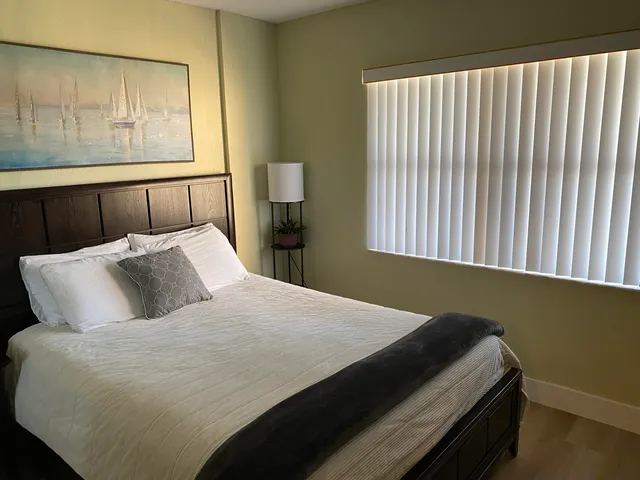 a bedroom with a bed and window