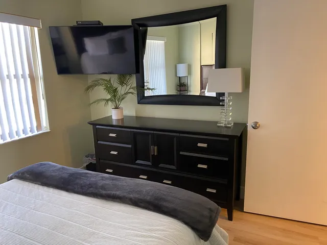 a bedroom with a bed and a dresser