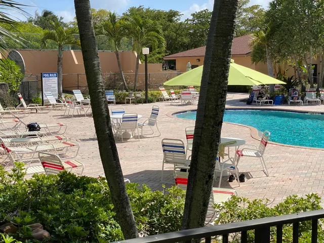 a view of a swimming pool with a patio and a garden