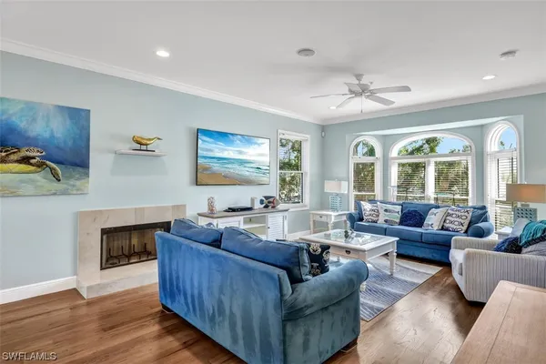 a living room with furniture a large window and a clock
