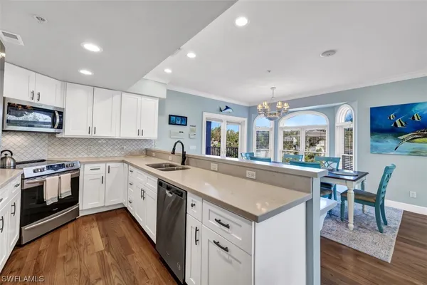 a large kitchen with a table and chairs in it