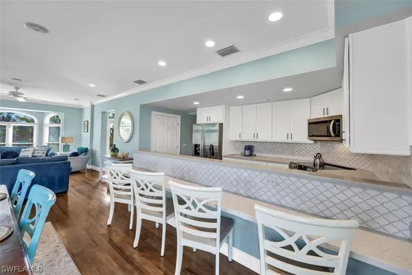 a kitchen with a sink cabinets and wooden floor