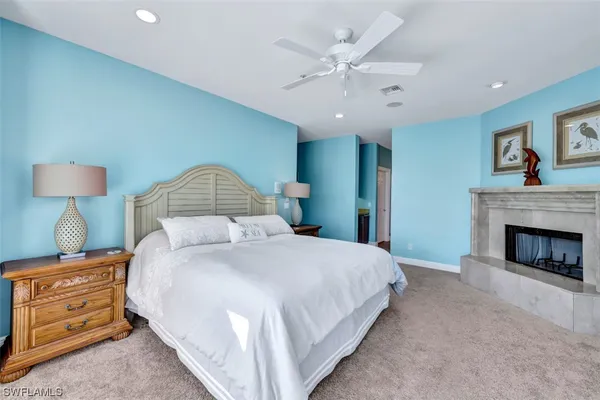 a spacious bedroom with a bed and a couch