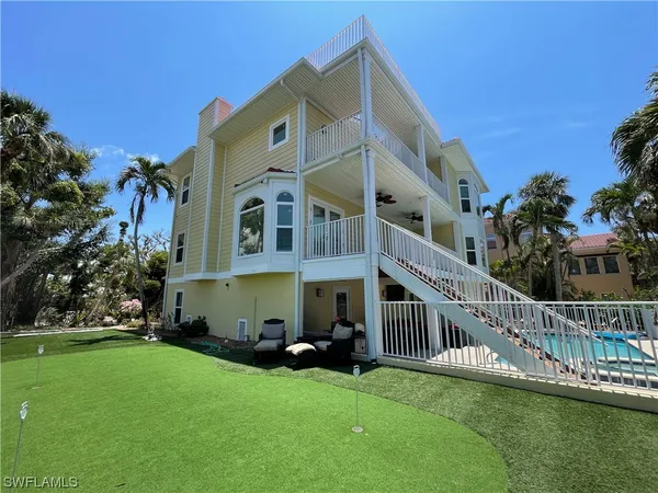 a view of a house with a deck front of house