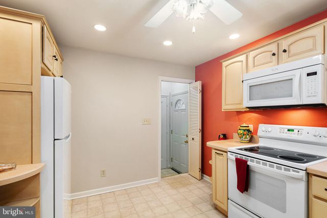 a kitchen with stainless steel appliances a refrigerator and a stove