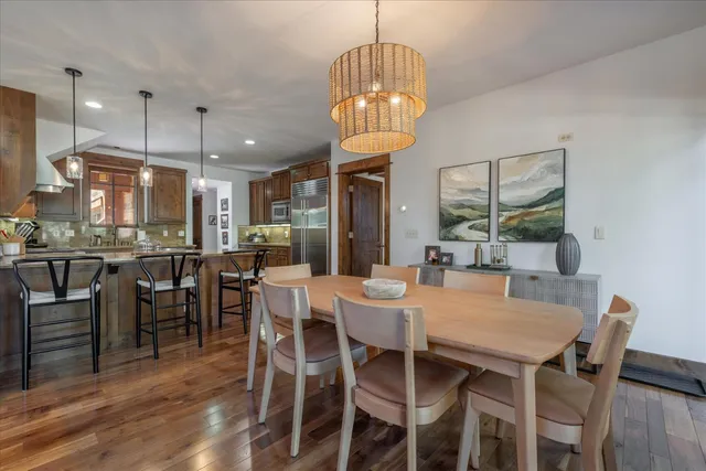 a view of a dining room with furniture wooden floor and chandelier