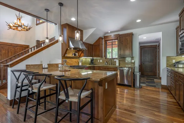 a kitchen with stainless steel appliances kitchen island a chandelier