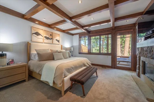 a spacious bedroom with a bed and a dresser next to a window