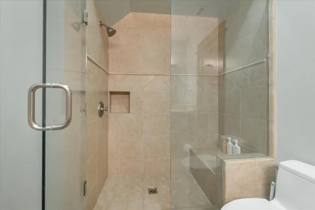 a bathroom with a shower a toilet and sink