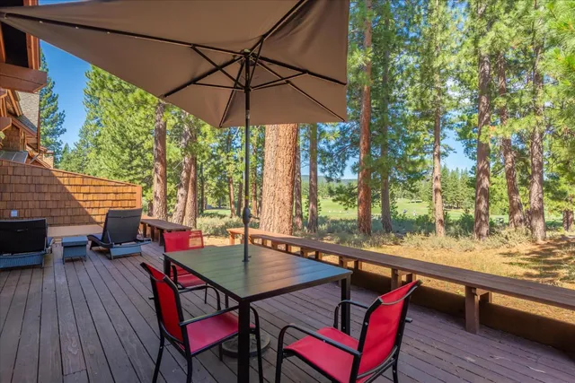 an outdoor sitting area with furniture and wooden deck