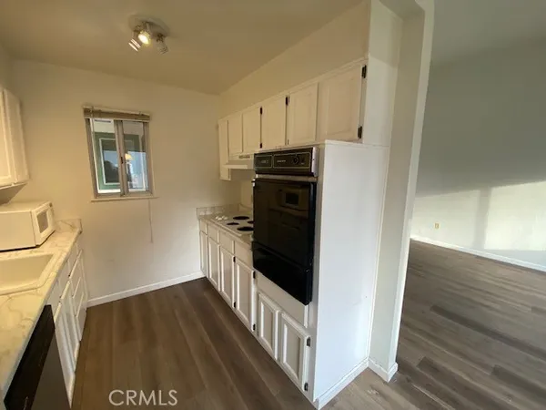 a kitchen with a refrigerator and a stove