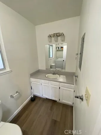 a bathroom with a double vanity sink mirror and toilet