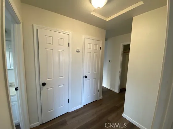 a view of a hallway with wooden floor