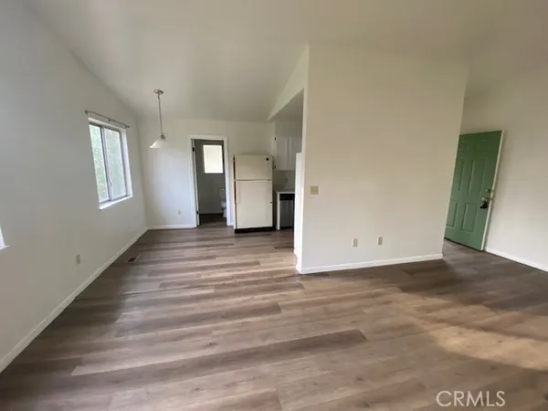 a view of a livingroom with wooden floor and a window