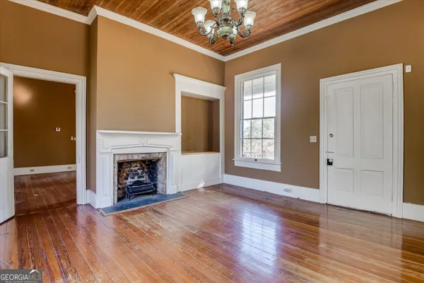 a view of a room with wooden floor and windows