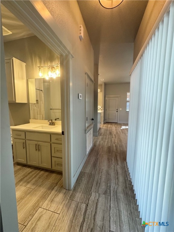 300 Hugo Road San Marcos, TX 78666 - Photo 12 of 23 a view of a bathroom with a sink and a mirror