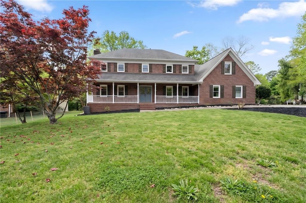 a front view of a house with a garden and plants