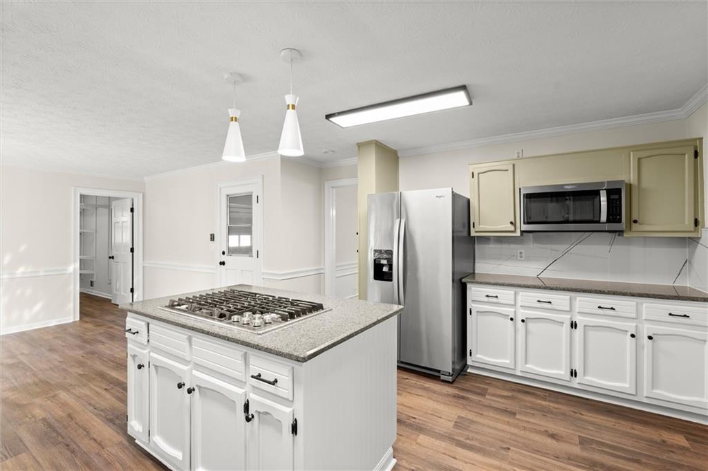4922 Signal Court Southwest Lilburn, GA 30047 - Photo 12 of 49 a kitchen with white cabinets and appliances