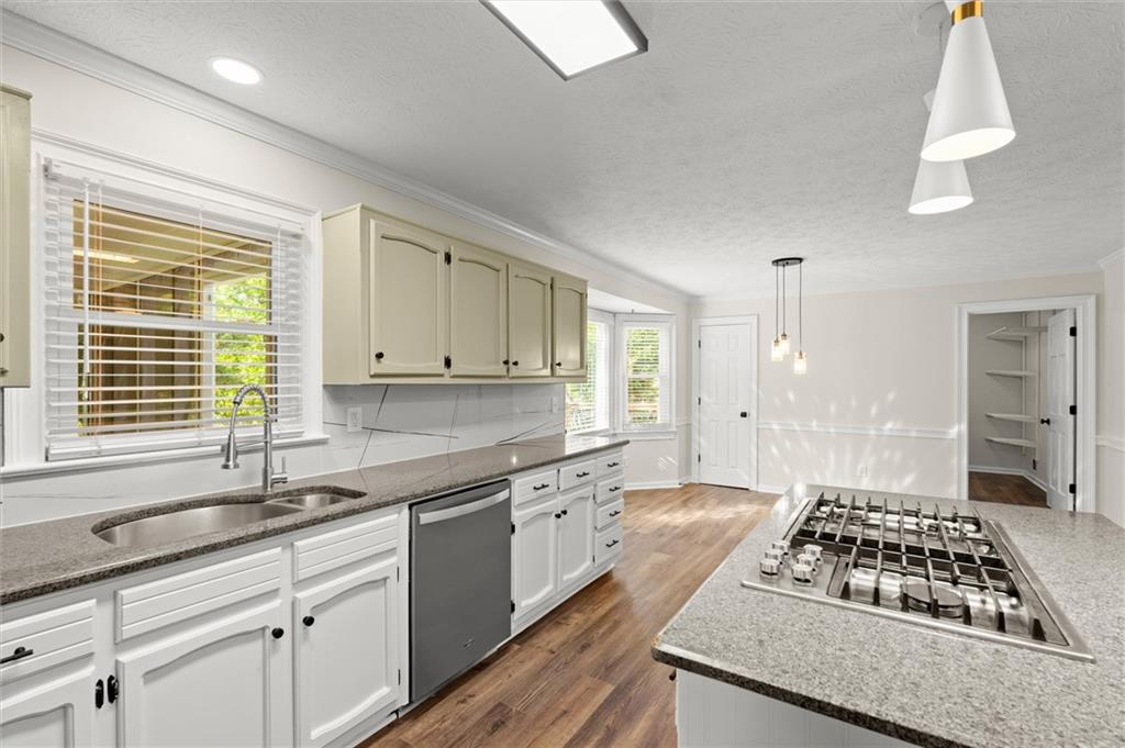4922 Signal Court Southwest Lilburn, GA 30047 - Photo 13 of 49 a kitchen with granite countertop a sink stove and cabinets