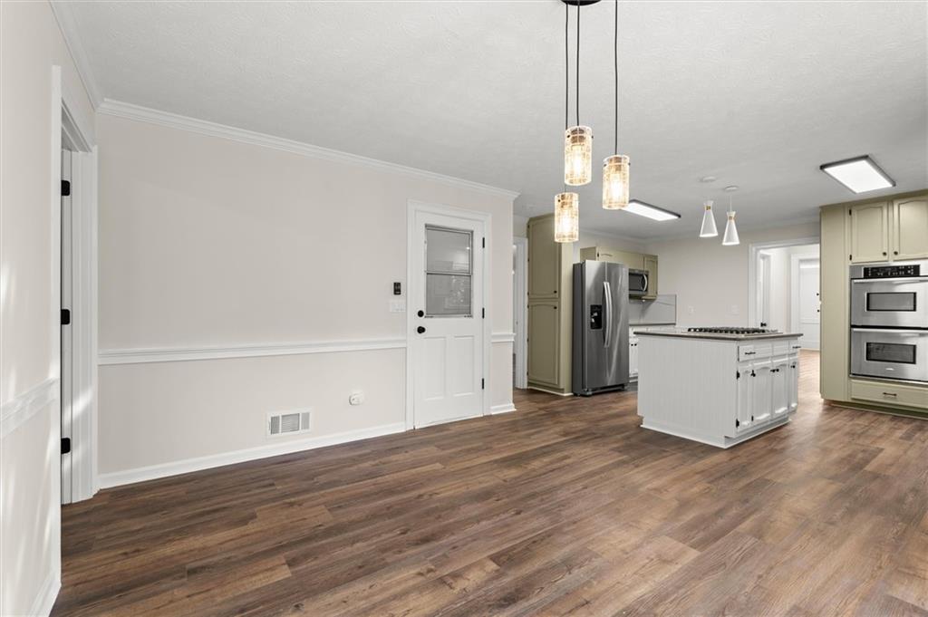 4922 Signal Court Southwest Lilburn, GA 30047 - Photo 14 of 49 a view of a kitchen with refrigerator and wooden floor