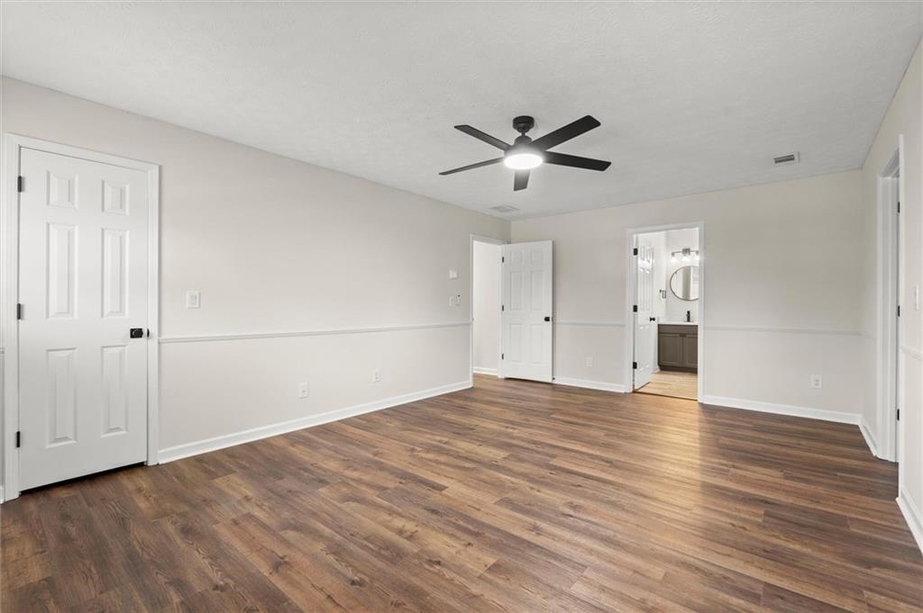 4922 Signal Court Southwest Lilburn, GA 30047 - Photo 23 of 49 a view of empty room with wooden floor and ceiling fan