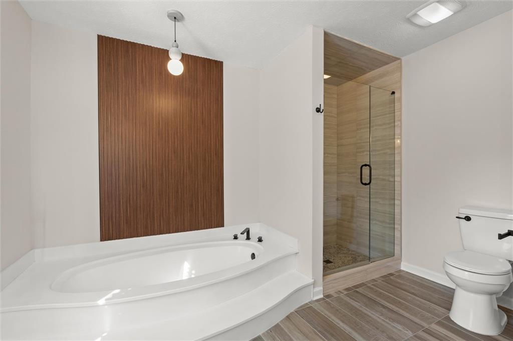 4922 Signal Court Southwest Lilburn, GA 30047 - Photo 27 of 49 a bathroom with a bathtub and a shower
