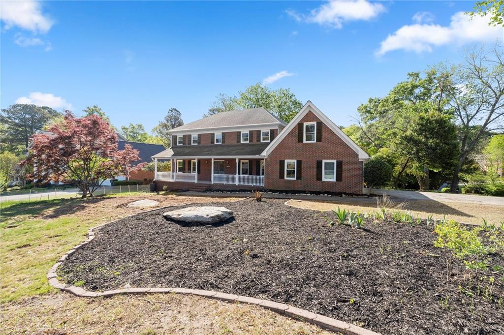 4922 Signal Court Southwest Lilburn, GA 30047 - Photo 3 of 49 a front view of a house with garden