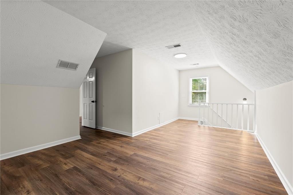 4922 Signal Court Southwest Lilburn, GA 30047 - Photo 31 of 49 wooden floor in an empty room with a window