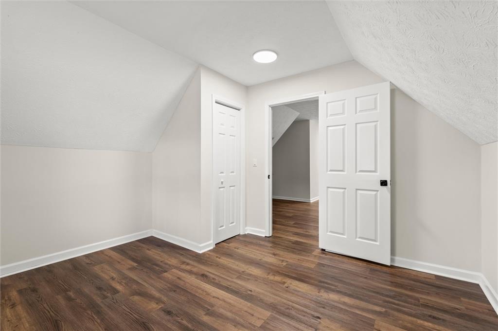 4922 Signal Court Southwest Lilburn, GA 30047 - Photo 33 of 49 a view of an empty room with wooden floor