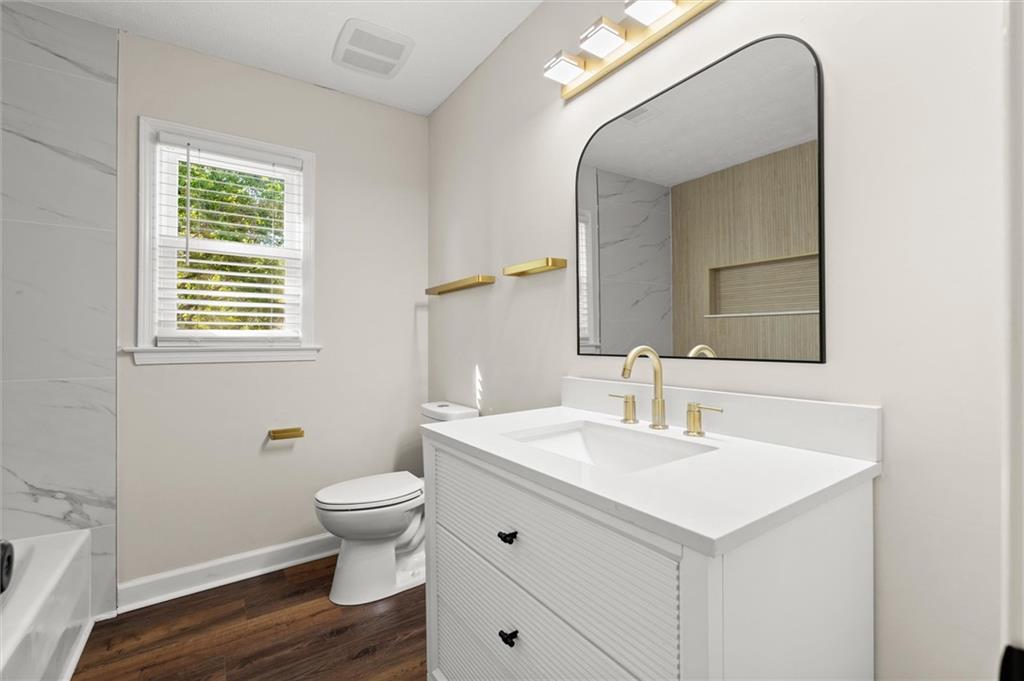 4922 Signal Court Southwest Lilburn, GA 30047 - Photo 34 of 49 a bathroom with a toilet sink and mirror